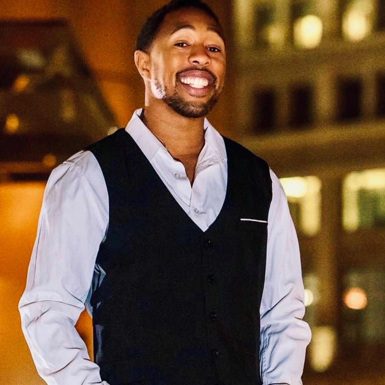 Darien Gray, REALTOR® with eXp Realty, smiling in a vest